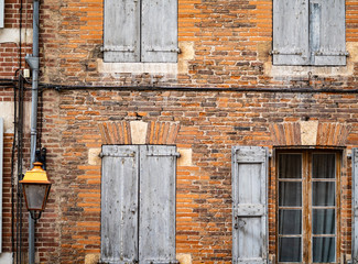One Window With Open Shutters In A Brick Wall