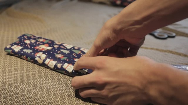 A Woman Busy Wrapping Her Present For The Christmas Holidays - Close Up Shot
