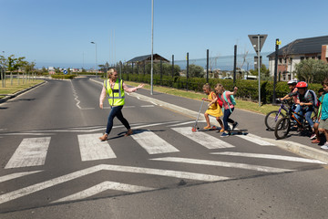 Woman wearing a high visibility vest on a pedestrian crossing