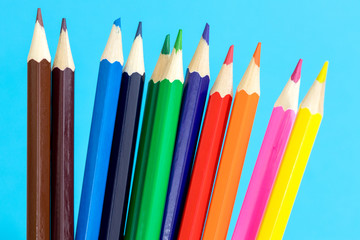 Fototapeta premium Multi color pencils on a blue background. School concept