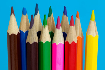 Multi color pencils on a blue background.  School concept
