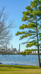 Fototapeta premium Water treatment plant by a lake on a sunny day.