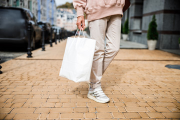 Woman carrying paper bag outdoors stock photo