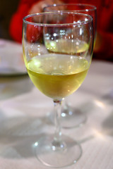 Table served for dinner  with glasses of cold white wine