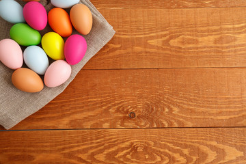 Colorful Easter Eggs On Cloth Wooden Background