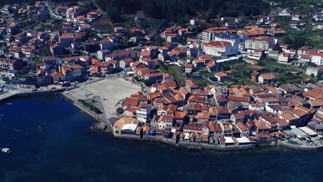 The Beautiful and Peaceful Scenery Of Different Houses and Blue Calm Ocean In Combarro - Aerial Shot