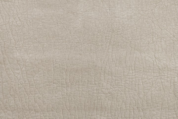 Fototapeta na wymiar The texture of genuine leather. Light beige background, surface.