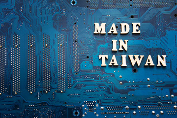 Inscription Made in Taiwan on a blue electronic printed circuit board. Background with copyspace...