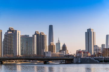 Fototapeta na wymiar Beautiful waterfront cityscape with historical buildings and modern skyscaper building on riverside (Haihe River) tianjin city, China
