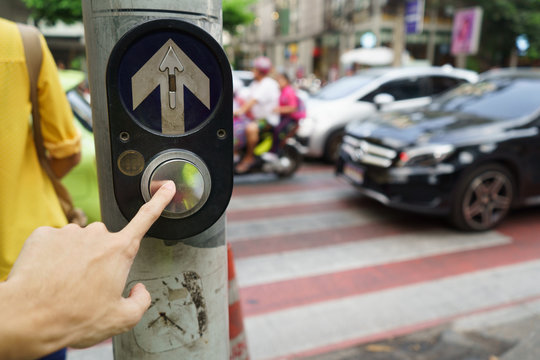 Pedestrian  pushing the button at the pedestrian crossing