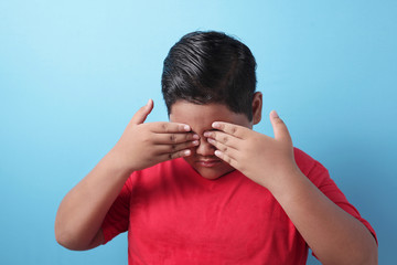 Fat Asian boy, looking down, sad and crying, bullied concept with copy space