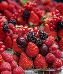 Berries in plastic baskets. Fresh strawberries, raspberries, blackberries, blueberries in takeaway cups. market. close-up