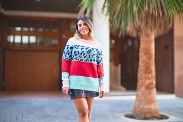 Young beautiful woman smiling happy and confident. Standing and walking at town street