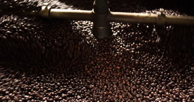 Close up of coffee beans being cooled down in roaster with soft light coming in from one side