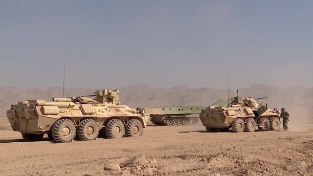 A military column of armored vehicles stopped in the desert to clear the road from mines and land mines, a military special operation, the work of sappers.