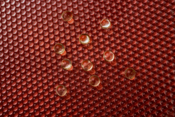 Capsules, pills on a red speckled background