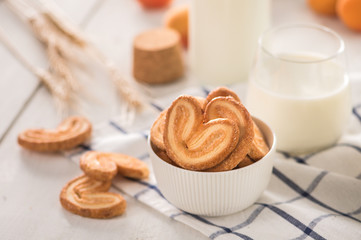 Crispy cookies with milk on light background