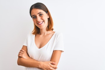 Beautiful redhead woman wearing casual white t-shirt over isolated background happy face smiling with crossed arms looking at the camera. Positive person.