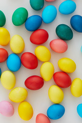 Above view of pastel colored Easter eggs arraigned in minimal composition on white background, copy space