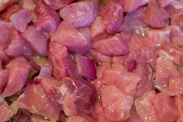 Sliced pork cook closeup in oil. Raw red meat in cooking
