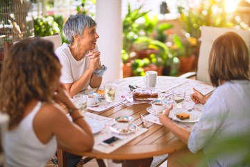 Young beautiful girl smiling happy and confident sitting dinking cup of coffee at terrace
