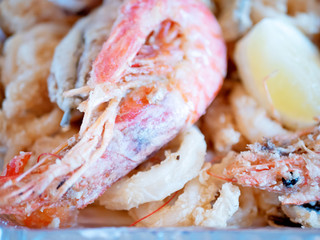 Typical Italian dish, mixed fried fresh fish with squid rings, sardines and shrimp