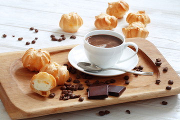 Profiteroles with coffee and chocolate on a white background