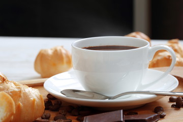 Profiteroles with coffee and chocolate on a white background