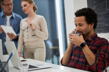 Afro american guy talking on cellphone at work