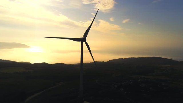 Aerial, pan, drone shot, of silhouette wind mills on the coast  at sunset, near of  A Coruna, Galicia, North Spain
