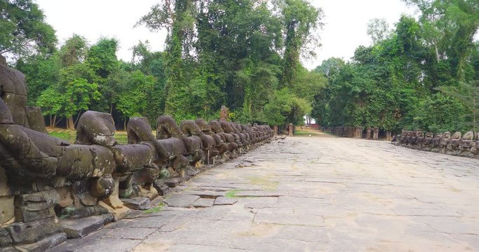 Entrance stone rock bridge gate ruin at Preah Khan temple Angkor Wat complex, Siem Reap Cambodia. A popular tourist attraction nestled among rainforest.