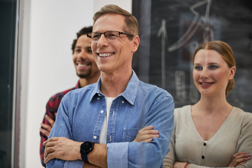 Cheerful business colleagues looking away and smiling