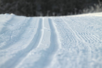 Ski track in snow , active winter holiday concept.