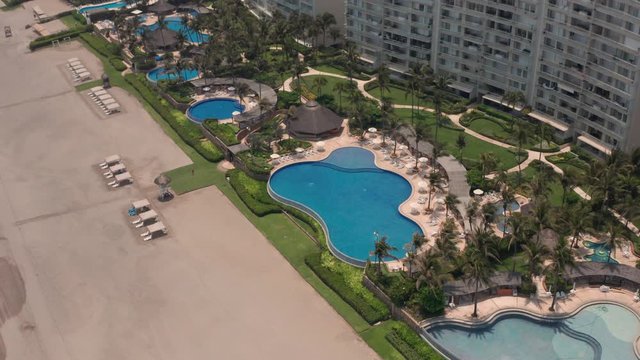 Static Aerial View of Pools Under Luxury Apartment Buildings in Famous Acapulco City, Mexico