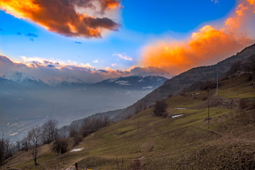 Mountain Panorama on sunset, blue and orange sky on italian alps