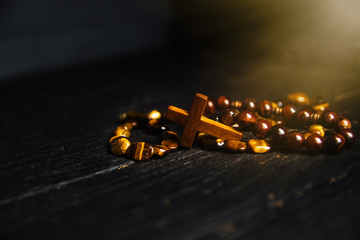 Christian cross necklace on darck background - as a symbol of the beginning of Great Lent,  Toned...