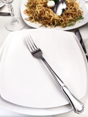Real life served table with empty plate, fork, tableware and snacks in official style