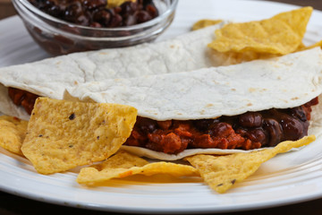 Tortilla with beans and corn chips detail