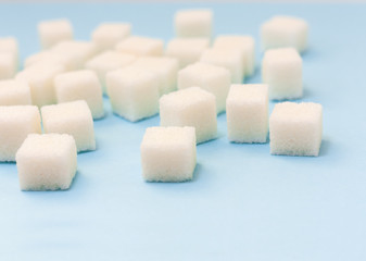 Sugar addiction, insulin resistance, unhealthy diet, sugar cubes on blue background, diabetes...
