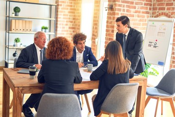 Group of business workers working together in a meeting. Listening one of them speaking at the office.