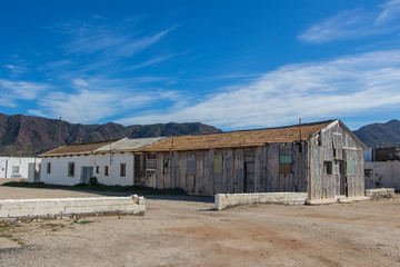old warehouses, two old warehouses one wooden and the other painted white, warehouses in the salt pans of the Natural Park of Cabo de Gata
