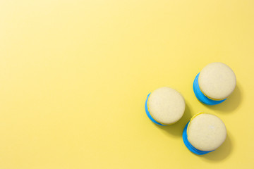 macaroni cookies on a yellow background with copy space