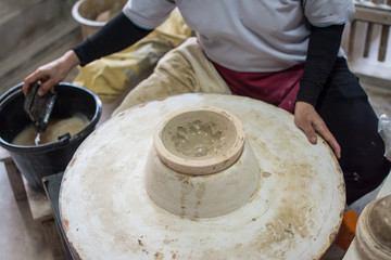 hands working clay on potter's wheel, Lampang in Thailand