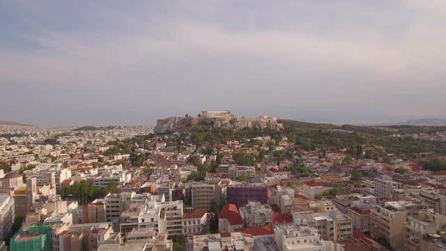 aerial drone shots above urban Athens old city capital of Greece and historical monument of Parthenon Acropolis sunny day establishment shot