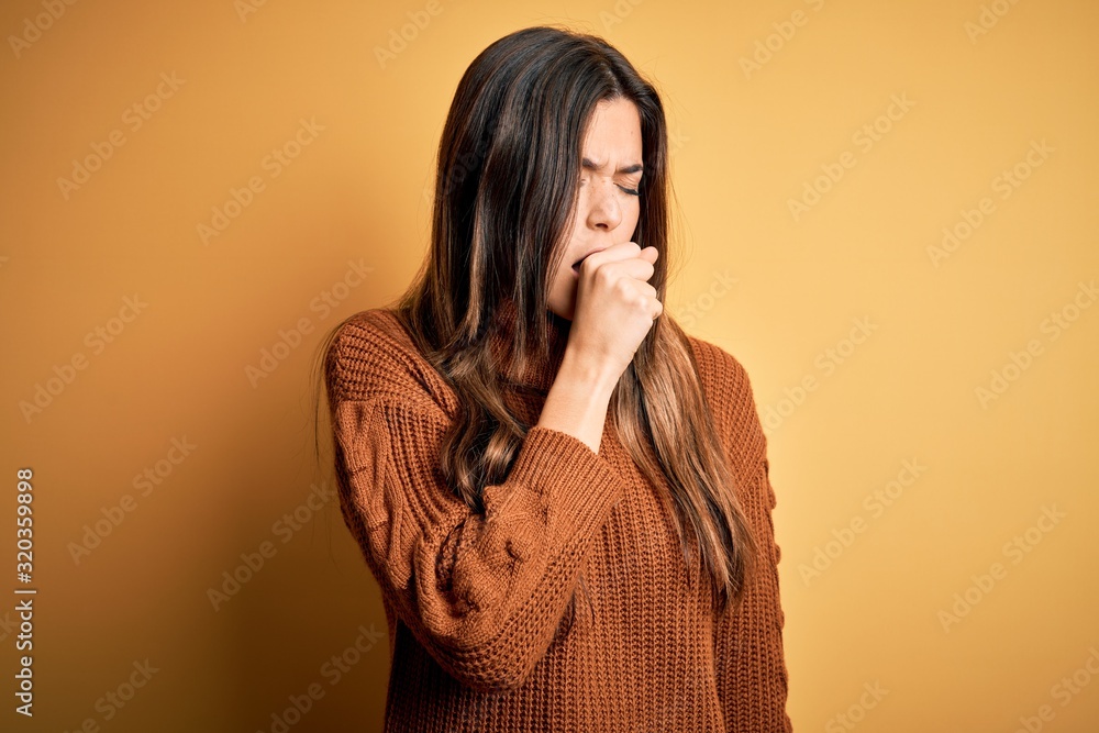 Canvas Prints Young beautiful girl wearing casual sweater standing over isolated yellow background feeling unwell and coughing as symptom for cold or bronchitis. Health care concept.