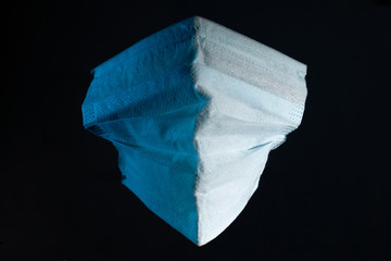 blue medical gauze mask on a dark background copy space. close up