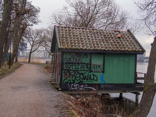 graffiti on wall of a hut by the lake