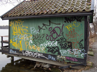 graffiti on wall of a hut by the lake
