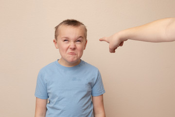 boy making funny faces while getting pointed at