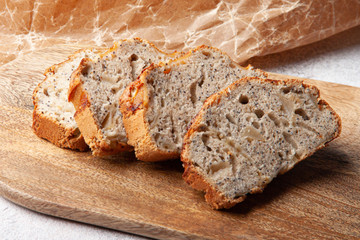 Pooppy cake with apple on wooden plate. Sliced pie.